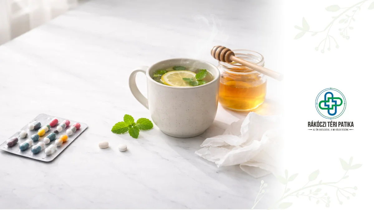 Köhögés elleni szirup mérőpohárral, kamillatea, méz és eukaliptusz levelek fa tálcán, háttérben kötött takaró a kanapén